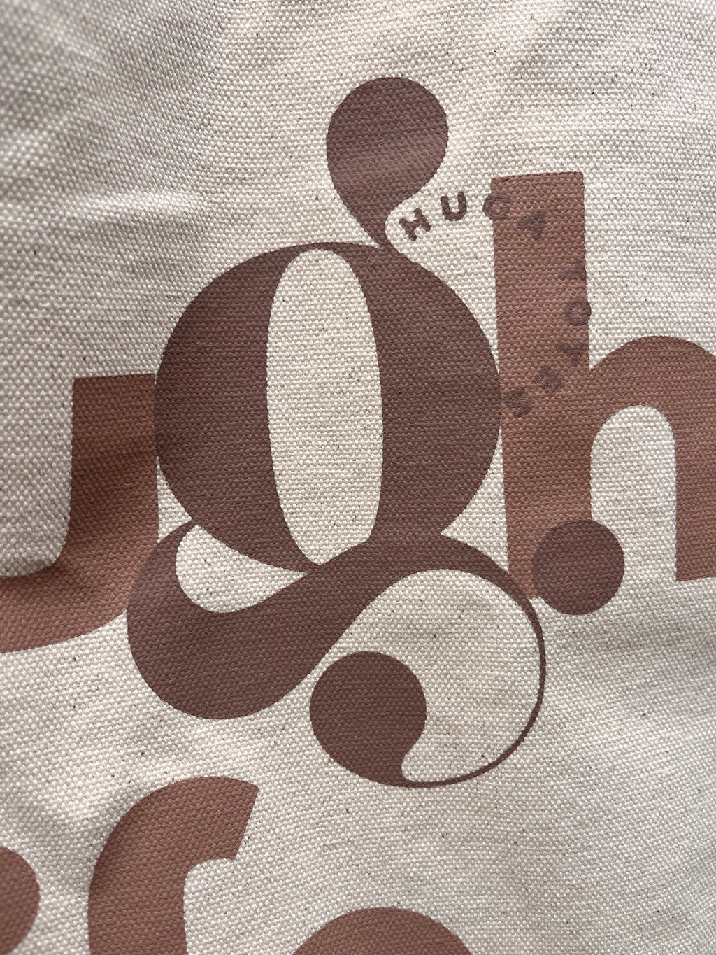 Close-up of a textured surface with brown lettering and design elements.