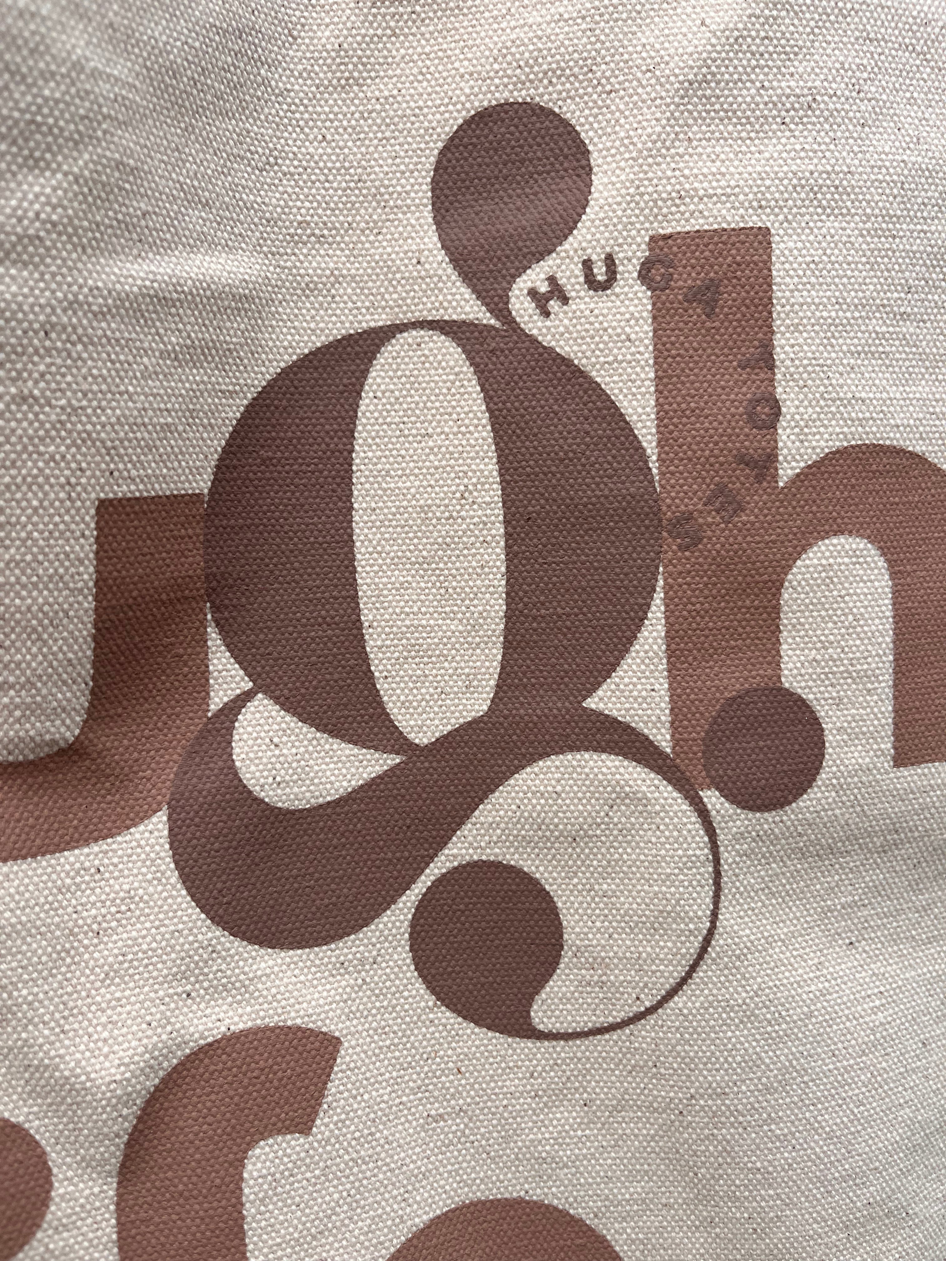 Close-up of a textured surface with brown lettering and design elements.